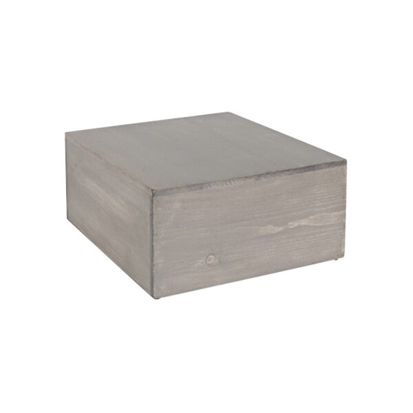 A grey wooden square display riser.