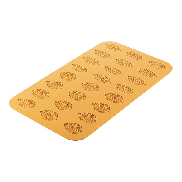 A yellow rectangular Silikomart silicone baking mold with a leaf pattern.