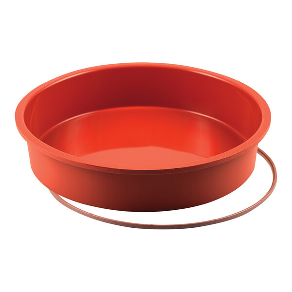 A red round silicone baking mold.