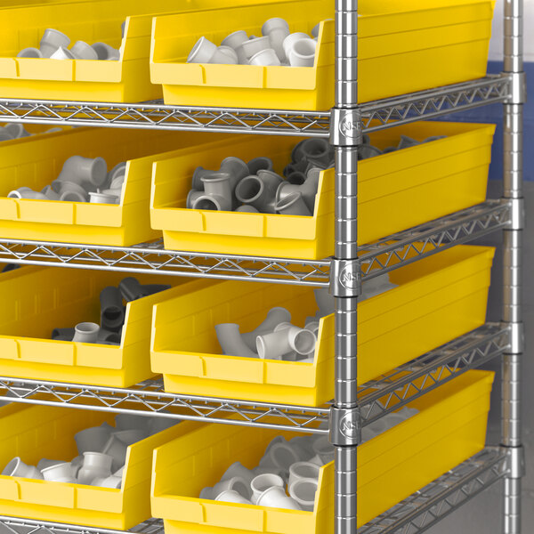A metal shelving unit with Regency yellow shelf bins.