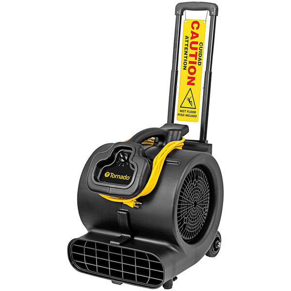 A black and yellow Tornado air mover with a yellow wet floor sign.
