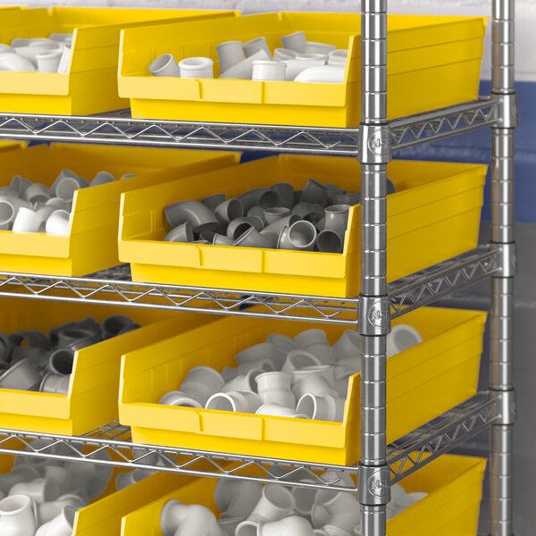 A metal shelving unit with Regency yellow shelf bins.