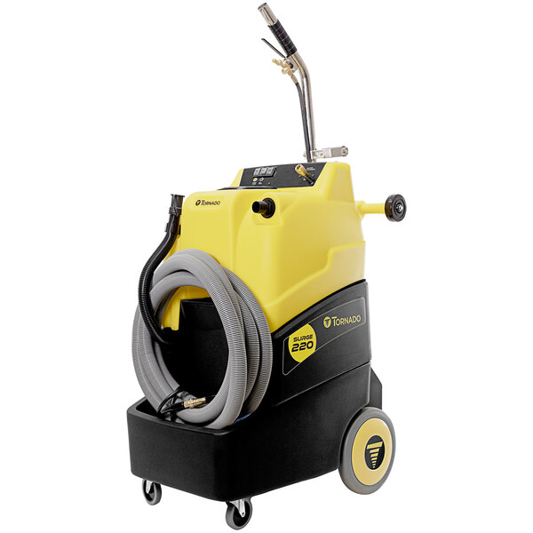 A yellow and black Tornado Surge carpet extractor with a grey hose.