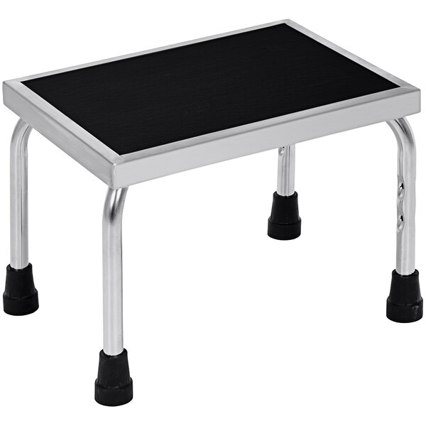A Vestil stainless steel step stool with black and silver accents.