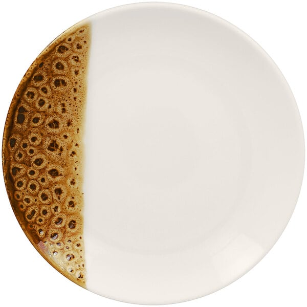 A white RAK Porcelain flat coupe plate with brown speckled surface.