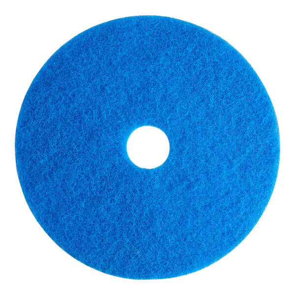 A blue Lavex Basics circular floor cleaning pad with a hole in the middle.