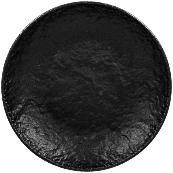 A close-up of a RAK Porcelain black deep coupe plate with a textured surface.