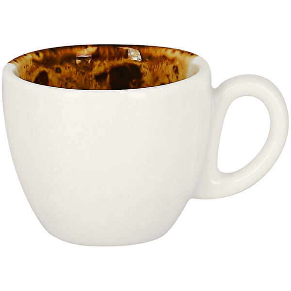 A white porcelain espresso cup with brown spots.