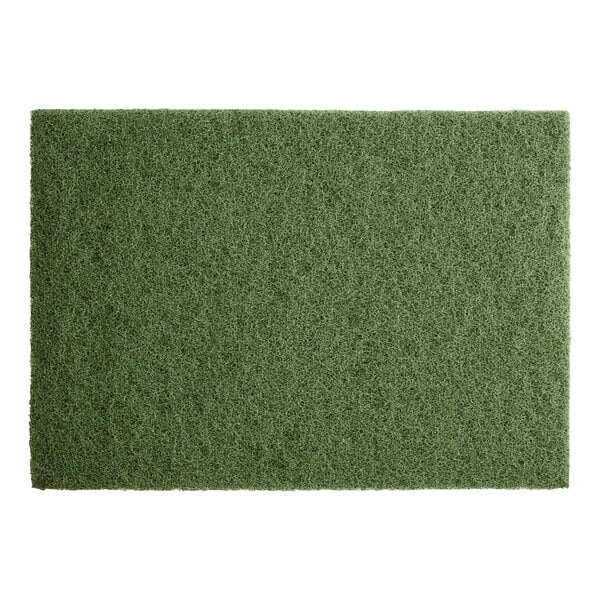 A close-up of a green Lavex Basics scrubbing floor machine pad.