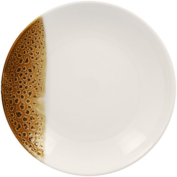 A white porcelain deep coupe plate with brown speckles.