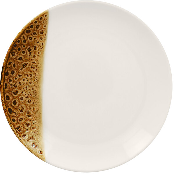 A white RAK Porcelain plate with brown speckles on it.
