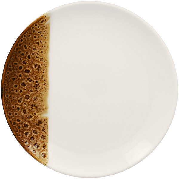 A white porcelain plate with brown spots on it.
