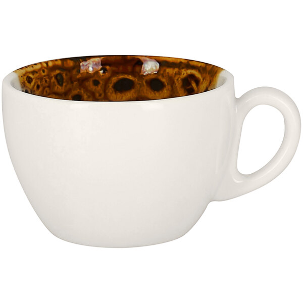A white porcelain coffee cup with brown spots on it.