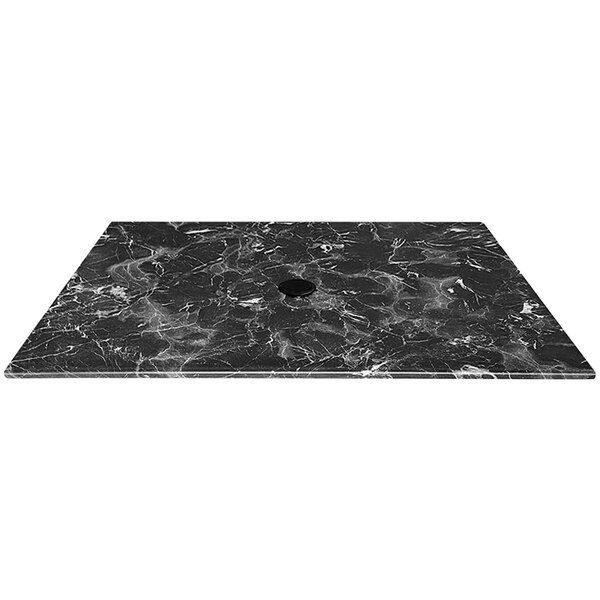 A black marble table top with a circle for an umbrella.