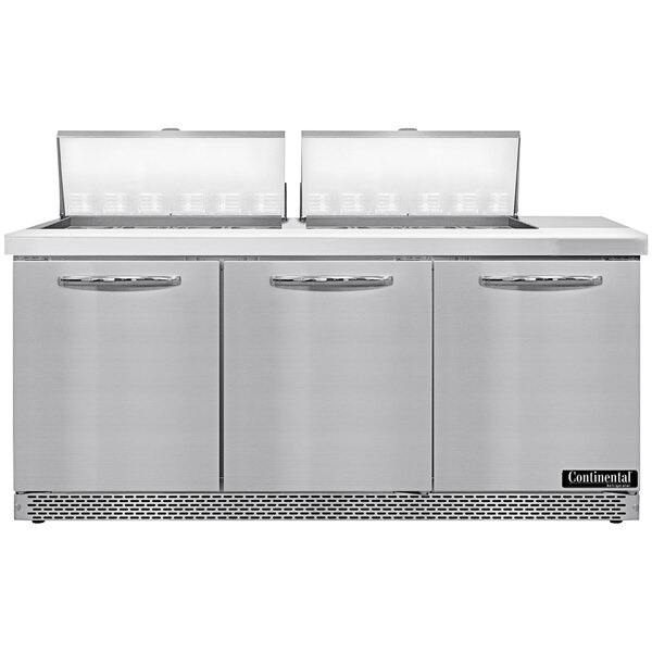 A stainless steel Continental Refrigerator with 3 doors above drawers.