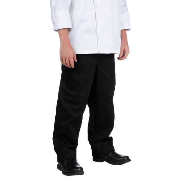 A person wearing Chef Revival black baggy chef pants and a white chef coat.