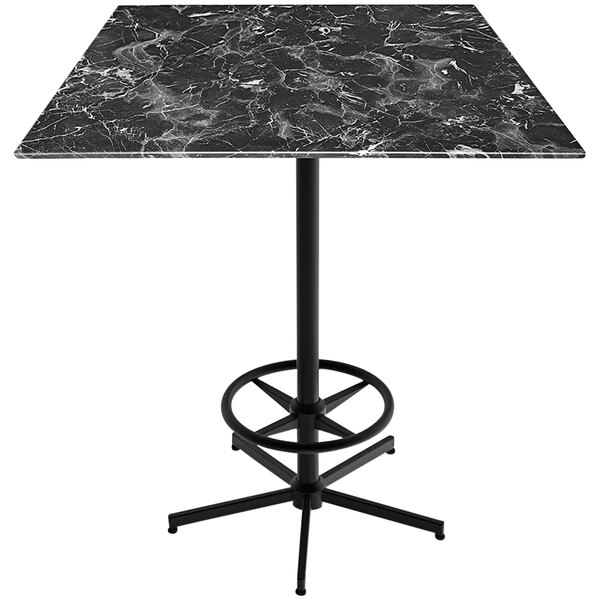 A black marble Holland Bar Stool bar table with a metal foot rest base.