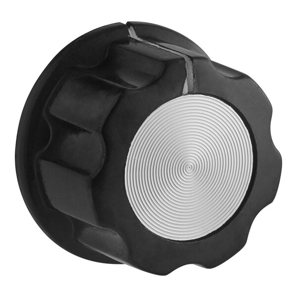 A black and silver temperature knob with a white center.