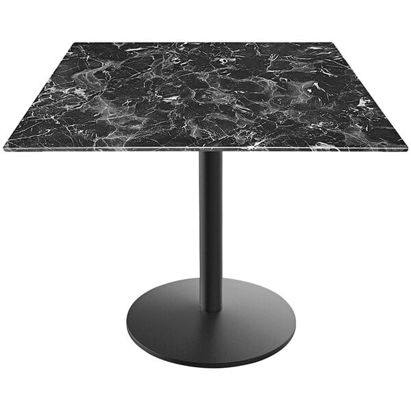 A Holland Bar Stool EuroSlim black marble table top on a round metal base.