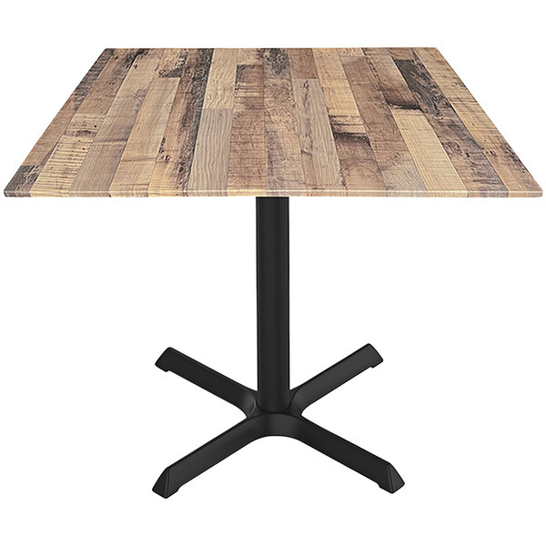 A Holland Bar Stool EuroSlim square table with a wooden top and black cross base.