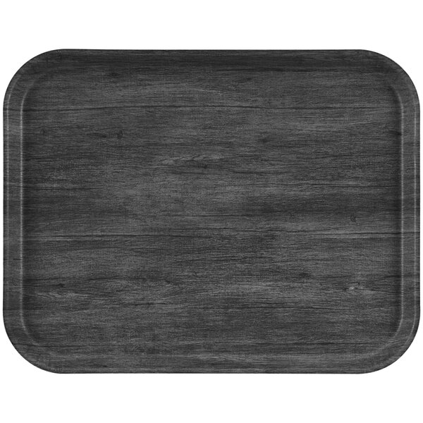 A black rectangular Cambro tray with a non-skid surface on a table.