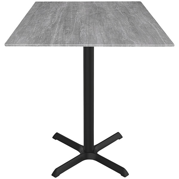 A Holland Bar Stool EuroSlim bar height table with a grey square top and black cross base.