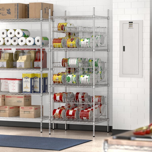 A Regency chrome wire shelving unit with can racks holding red and white food containers.