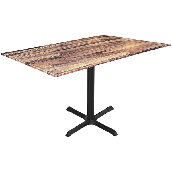 A Holland Bar Stool rustic wood table with a black cross base.