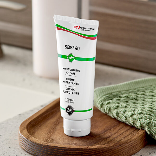 A white tube of SC Johnson Professional SBS 40 Skin Conditioning Cream with black and green text.