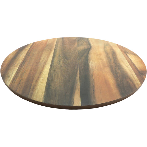 A round brown faux wood melamine board on a table.