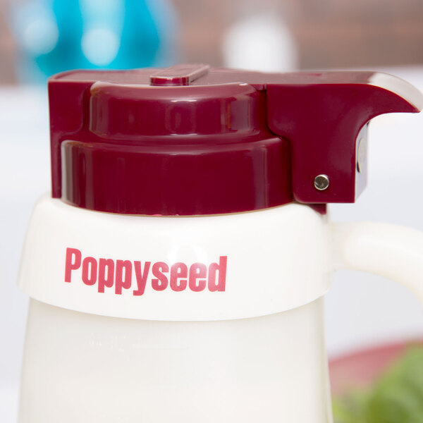 A white plastic Tablecraft salad dressing dispenser collar with red lettering.