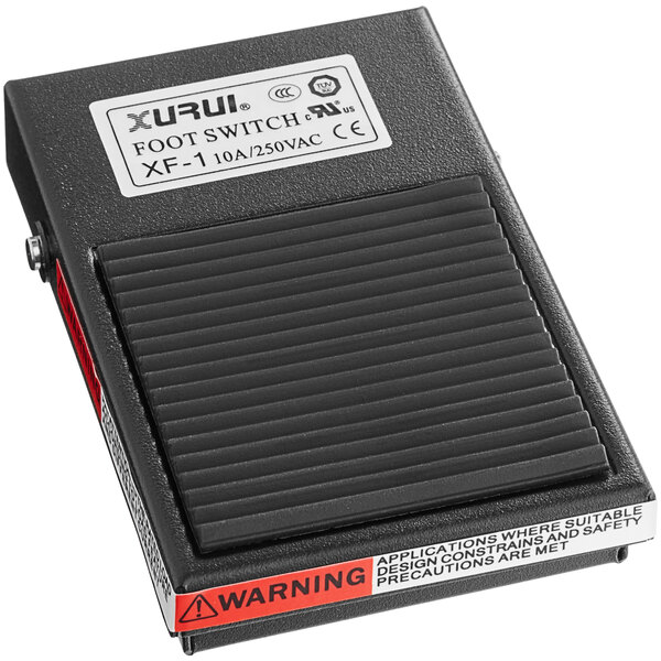 A black foot pedal with a red and white label.