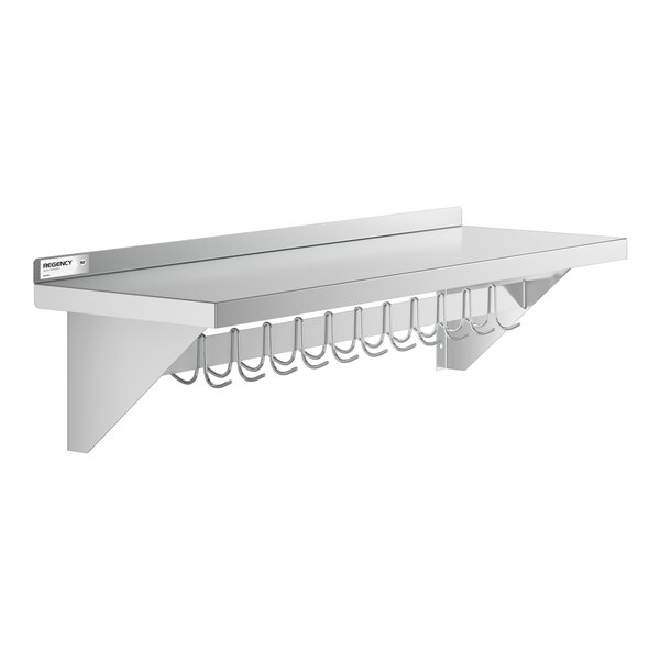 A wall-mounted stainless steel shelf with a row of metal hooks hanging underneath.