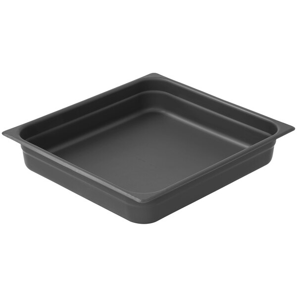 A black square LloydPans aluminum steam table pan with a lid on a counter.