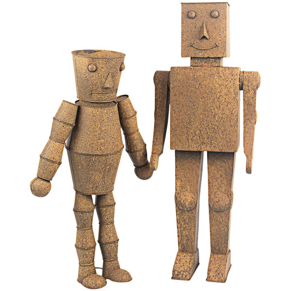 Two brown metal robot figures with a metal face and nose holding hands.