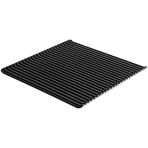 An anodized aluminum grill pan with a black square object with lines.