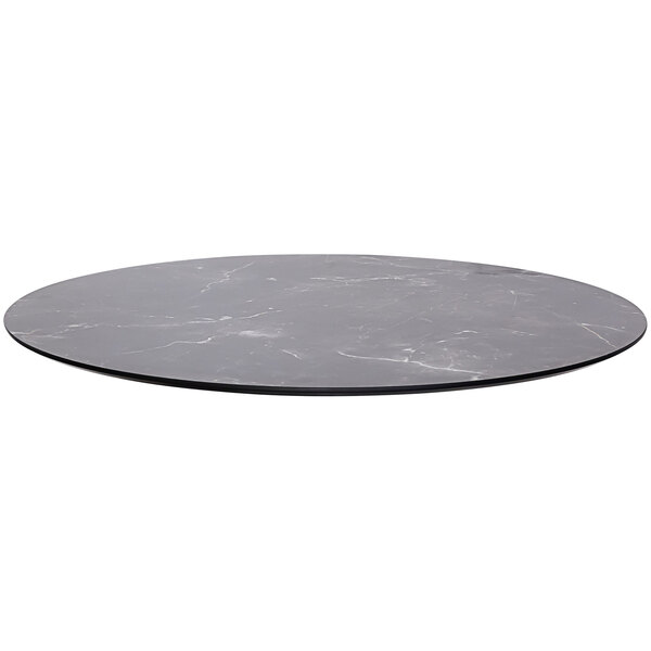A black circular surface with a knife edge on a table
