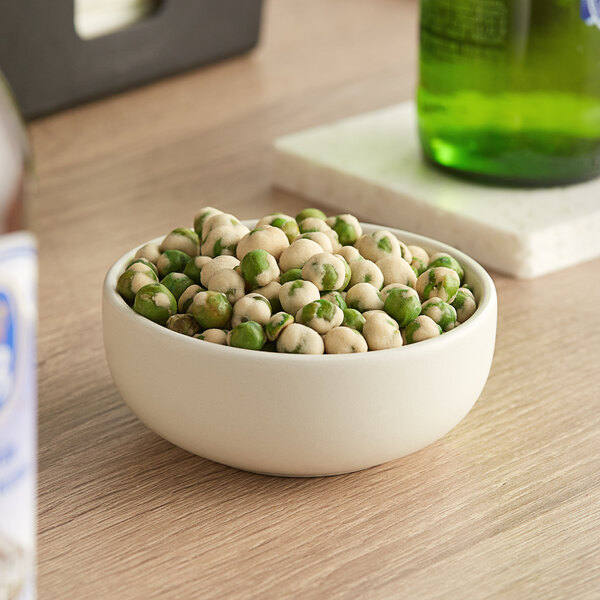 A bowl of Green Wasabi Peas on a table.