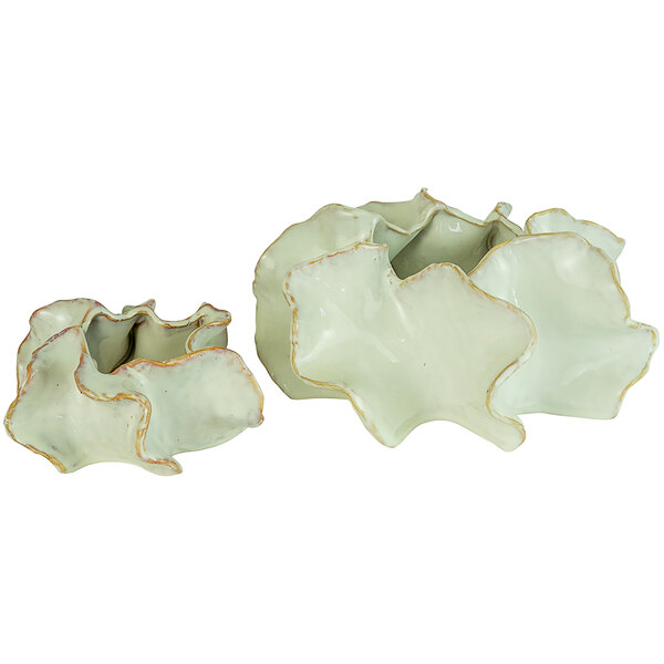A set of two small green and white ceramic planters with leaf designs.