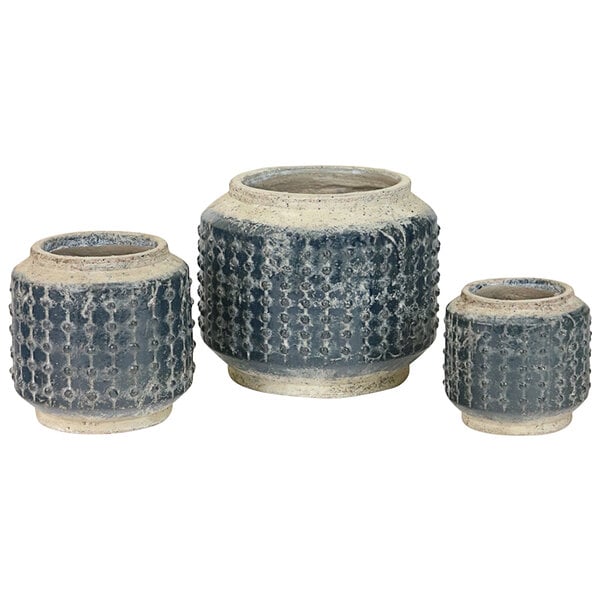 Three small dark blue ceramic pots with designs on them.