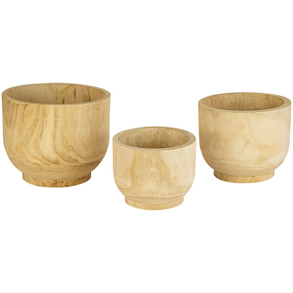 A group of wooden bowls with handles.