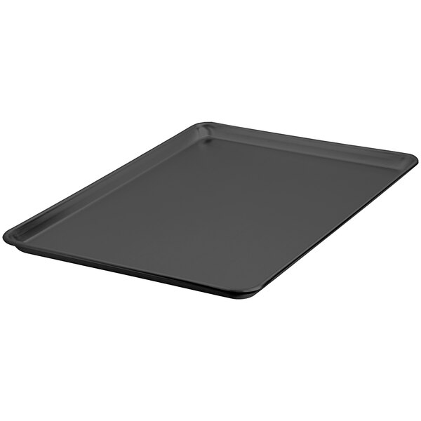 A black rectangular LloydPans bun sheet pan with a Dura-Kote finish on a counter.