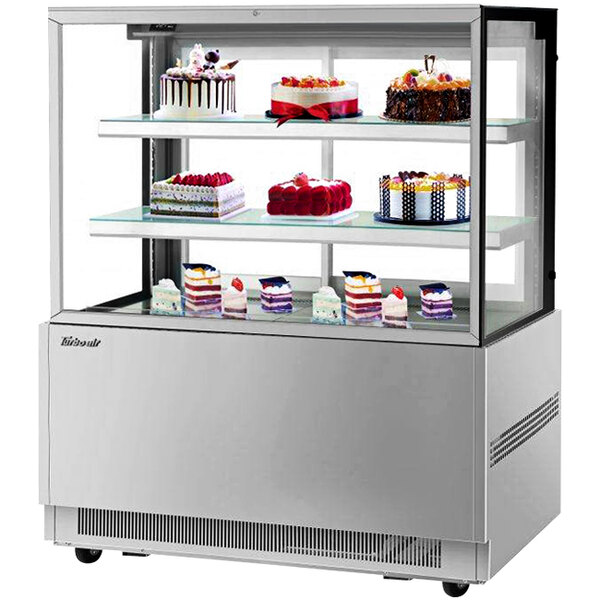 A Turbo Air refrigerated bakery display case with cakes on shelves.