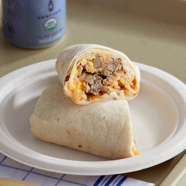A Tres Picosos Western Breakfast Burrito with sausage, eggs, and cheese on a plate.