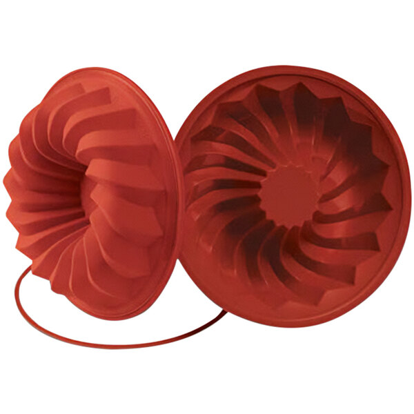 A red silicone mold with a circular pattern.