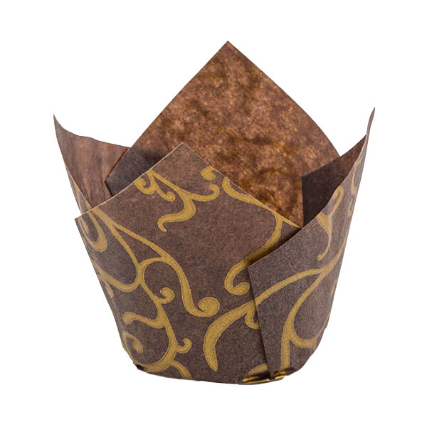 A close-up of a brown paper Novacart tulip baking cup with gold designs.