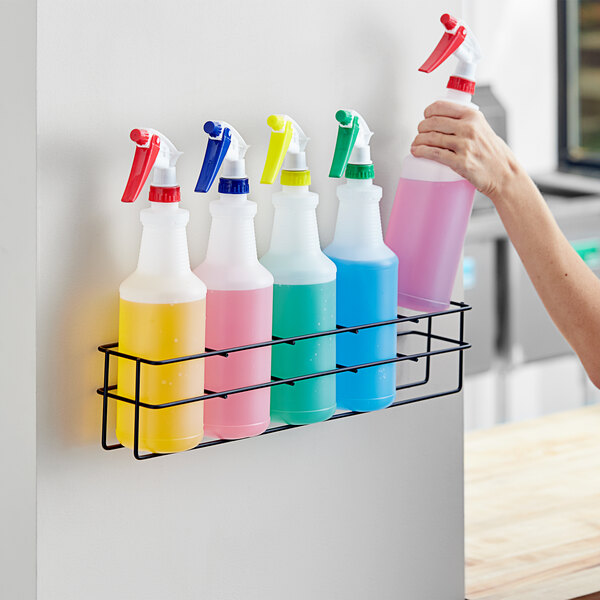 A Lavex wall-mount rack holding 5 spray bottles.