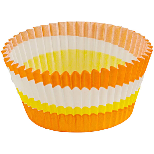 An orange Novacart fluted baking cup with a circle pattern.