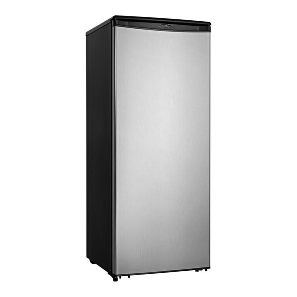 A black and stainless steel Danby hotel refrigerator with a white rectangular object inside.