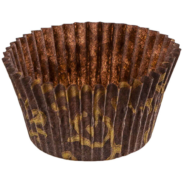 A close-up of a brown paper Novacart cupcake wrapper with gold designs.